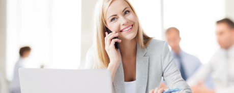 business concept - businesswoman talking on the phone in office